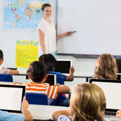 Schoolchildren using tablets against teacher Schoolchildren using tablets against teacher