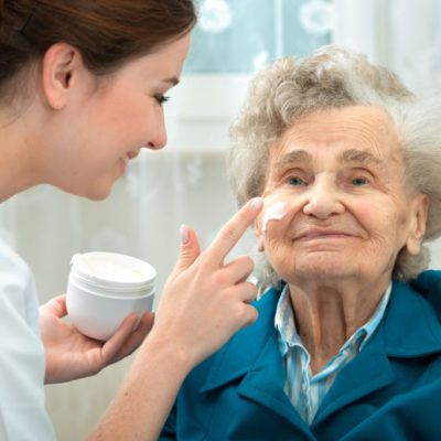 Elderly woman is assisted by nurse at home